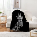 Detail of plush black flannel blanket featuring a realistic giraffe head print on a sofa - Giraffe Head Style (Style 9)