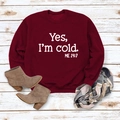 Detail of burgundy sweatshirt featuring Yes I'm Cold slogan print on wood background - S / Burgundy