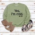 Detail of sage green sweatshirt featuring Yes I'm Cold print on vintage wood background - S / Olive Green