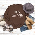 Flat lay of brown cotton sweatshirt with Yes I'm cold print on rustic wood background - S / Coffee