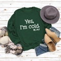 Close-up of Yes I'm Cold print on green sweatshirt styled with autumn accessories - S / Dark Green