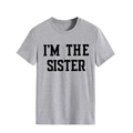 Detail view of the I'M THE SISTER bold black lettering on gray crewneck t-shirt - S / Light Gray (Black Font)