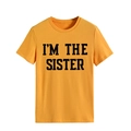 Close-up of black 'I'M THE SISTER' slogan print on a bright yellow cotton T-shirt - S / Mustard Yellow (Black Text)