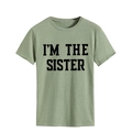 Close-up of I'M THE SISTER bold letter print on light green cotton t-shirt fabric - S / Olive Green (Black Font)