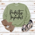 Flat lay of sage green sweatshirt with Perfectly Imperfect print and plaid scarf - M / Olive Green Sweatshirt (Black Font)