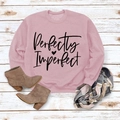 Flat lay of pink sweatshirt with Perfectly Imperfect lettering on white wood floor - M / Pink Sweatshirt (Black Font)