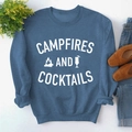 Flat lay of navy sweatshirt with Campfires and Cocktails print on textured surface - S / Blue Sweatshirt (White Font)