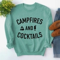 Flat lay of mint green long sleeve sweatshirt with Campfires and Cocktails graphic - S / Light Green Sweatshirt (Black Font)