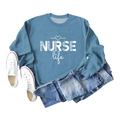 Flat lay of blue crewneck sweatshirt with NURSE Life heart print and denim jeans - S / Blue (White Font)