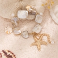 Ocean style bracelet with natural shells, white pearls, and golden starfish charms - Gold Bracelet(2460)