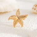 Macro detail of golden starfish brooch featuring textured grain and polished finish - Gold Textured Sea Star Style (03554)