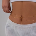 Chic double-layered gold waist chain with delicate metal beads and a tassel drop on model - Gold