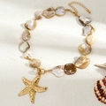 Macro detail of seashell choker with golden starfish pendant and iridescent pearls - Gold Starfish MOP Necklace Style (06659)