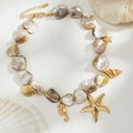 Macro detail of iridescent shell necklace with golden starfish and seahorse charms - Gold + White Sea Creature Charm Style (06675)