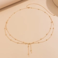 Detail of layered gold waist chain with fine beads, lobster clasp and extension links - Tassel Bead Style (01705) / Gold