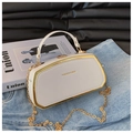 Macro view of white rigid box bag with gold metal frame and fashion bag inscription - White