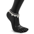 Detail of silver anklet featuring white pearls, starfish and seashell charms on foot model - Silver