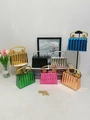 Close-up of pleated metallic evening clutch bags with lion head handles in seven colors - Gold