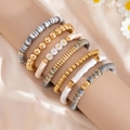 Detail of stacked boho bracelets with MAMA letter beads and soft clay Heishi discs - Polymer Clay Puzzle Style (06038)