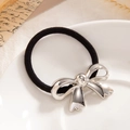Minimalist elastic hair tie featuring a polished silver metallic bow pendant - Silver-0087
