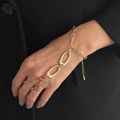 Adjustable golden finger bracelet with bold links and oval metal clasp on wrist - Oval Loop Hand Harness (03063) / Gold