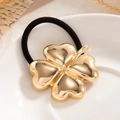 Elegant black ponytail holder with a large polished gold four-leaf clover heart charm - Gold Clover (0068)