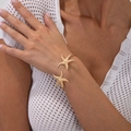 Detailed view of gold starfish open cuff bracelet with textured metallic sea element - Multi Starfish Design (2870) / Gold