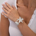 Macro shot of silver metal starfish and shell cuff bracelet on a model's wrist - Large Starfish Design (2874) / Silver
