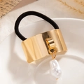 Minimalist gold metal hair tie with irregular baroque pearl pendant on white background - Wide Curved Cuff Pearl Gold (0094)