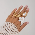 Close-up of bohemian gold ring set with baroque pearl and white flower charms on hand - Artificial Pearl Flower 7-Piece Set(6136) / Light Gold and White