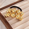 Elastisch haarelastiekje met getextureerde goudlegering kralen in geometrisch design - Bolletjes Rij (0103) / Goud