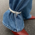 Double-row pearl anklet with rhinestone cross pendant worn over blue denim jeans - Pearl Cross Fringe Style (0905)