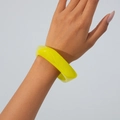 Close-up of a chunky translucent yellow acrylic bangle with a polished minimalist finish - Yellow & Green