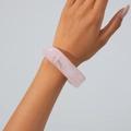 Macro shot of a chunky pink marble resin bangle with translucent white textures on wrist - Light Pink