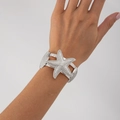 Macro detail of silver seashell and starfish cuff bracelet on model wrist - Silver-Wide Starfish Shell Style (02874)