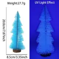 Light blue 20cm mini Christmas tree with wooden base showing blue fluorescence under UV light - 20cm Fluorescent Blue Tower Tree