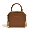 Brown octagonal crossbody bag with golden metal edges and twisted handle detail - Dark Brown