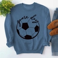 Detailed view of Game Day text and football print on a blue crewneck sweatshirt - S / Blue (Black Font)