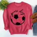 Detailed view of red GAME DAY sweatshirt with ribbed cuffs and hem on flat lay - S / Red (Black Font)