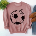 Flat lay of pink Game Day sweatshirt with soccer print and casual accessories - S / Rose Gold (Black Font)