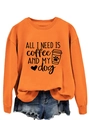 Detail of orange crewneck sweatshirt fabric showing ALL I NEED coffee and dog text - Orange (Black Font)