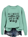 Close-up of mint green sweatshirt featuring ALL I NEED IS coffee AND MY dog print - Light Green (Black Text)