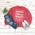 Detail of red crewneck sweatshirt with white Tennessee whiskey lettering and denim jeans - Red (White Font)