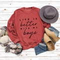 Flat lay of a red round neck sweatshirt with Life is Better text and autumn decor - S / Red (Black Font)
