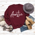 Flat lay of burgundy Auntie sweatshirt with autumn accessories on white wood - S / Wine Red Sweatshirt (White Font)