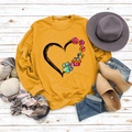 Close-up of mustard yellow sweatshirt with rainbow heart and dog paw print detail - S / Yellow