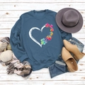 Teal blue sweatshirt with colorful heart and paw print on white wooden background - S / Blue