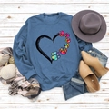 Flat lay of navy blue sweatshirt with colorful paw heart print and autumn accessories - S / Blue