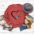 Detail of red crewneck sweatshirt featuring artistic heart and dog paw prints - S / Red