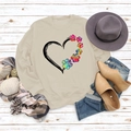 Close-up of heart and colorful dog paw print on beige long sleeve sweatshirt - S / Sand
